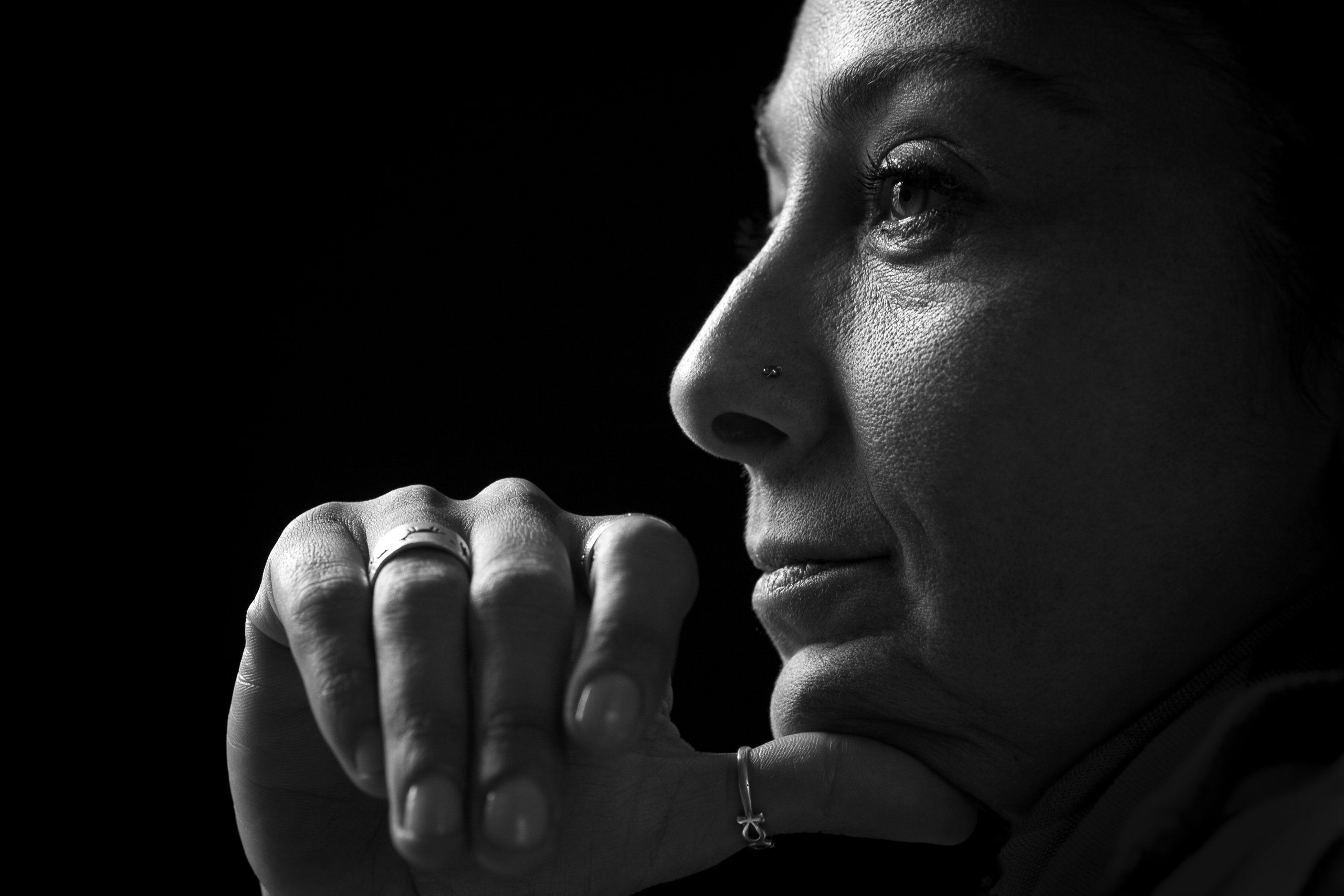 Woman shrouded in black looking off into distance